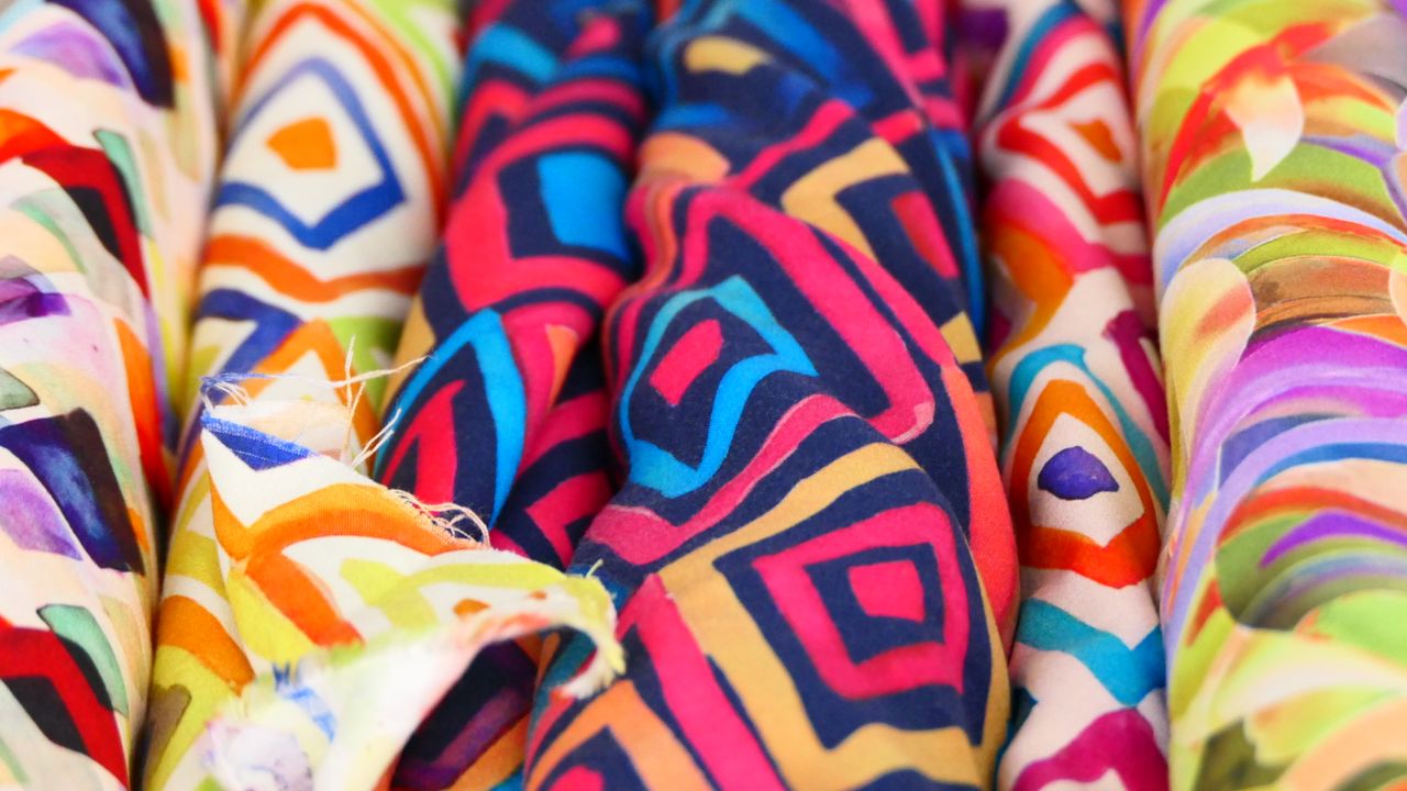 services-img Vibrant geometric patterned fabrics on display, featuring bold colors and intricate designs.